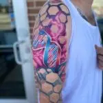 Color DNA helix tattoo with geometric details by All City Tattoo