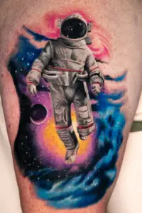 Color galaxy astronaut tattoo by All City Tattoo